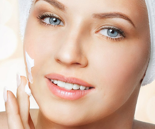 Woman applying face cream