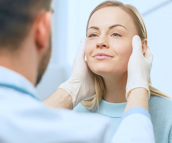 Professional checking a patients skin